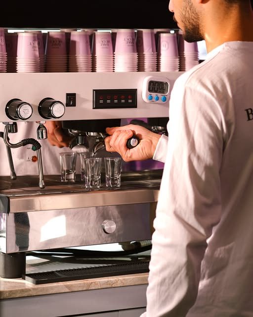 Barista pulling espresso shots